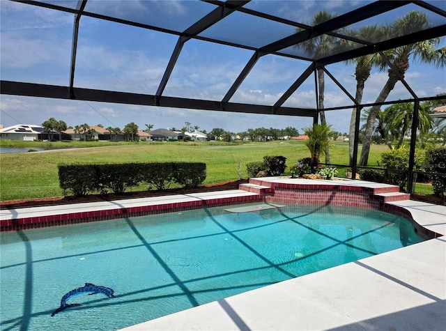 pool with a lanai and a yard