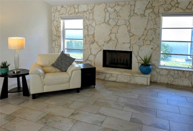 living room featuring a stone fireplace