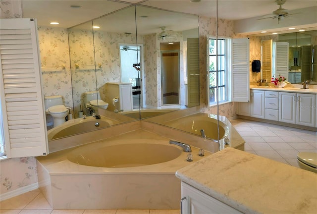 bathroom featuring wallpapered walls, tile patterned flooring, toilet, a ceiling fan, and a bath