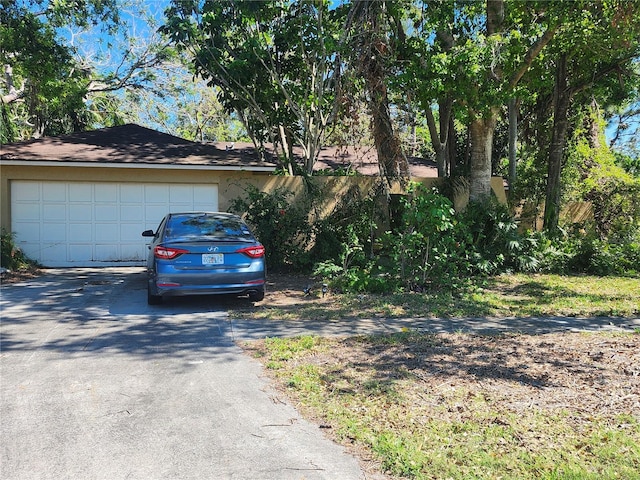 1862 Orangewood Ln, Sarasota, FL 34232 - view of side of property with driveway and a garage
