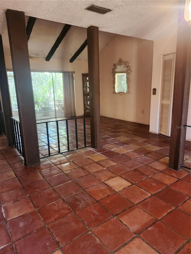 1862 Orangewood Ln, Sarasota, FL 34232 - unfurnished room with tile patterned flooring, visible vents, a textured ceiling, and vaulted ceiling with beams