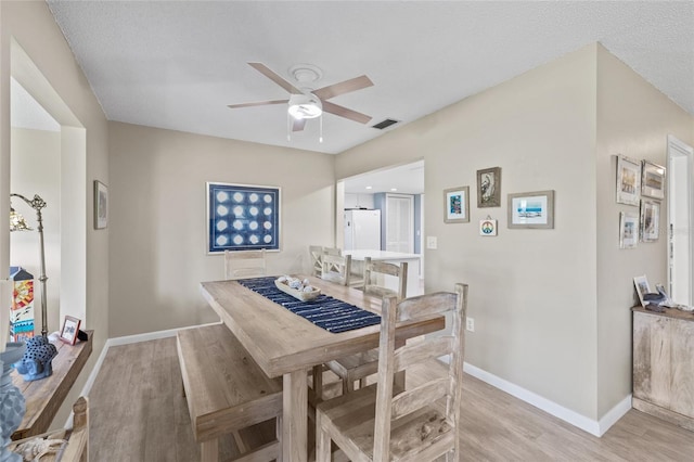 7122 11th Ave W, Bradenton, FL 34209 - dining area with visible vents, baseboards, light wood-style floors, and ceiling fan
