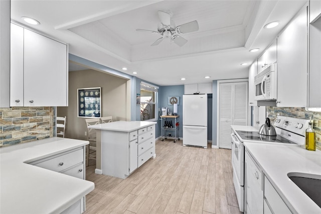 7122 11th Ave W, Bradenton, FL 34209 - kitchen featuring white appliances, white cabinets, and a tray ceiling