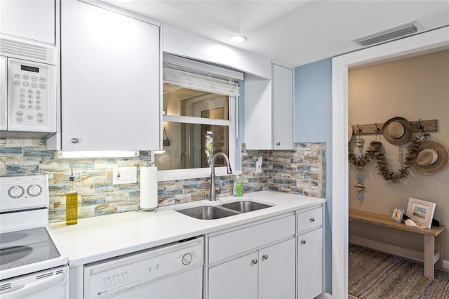 7122 11th Ave W, Bradenton, FL 34209 - kitchen featuring visible vents, white cabinets, white appliances, and a sink