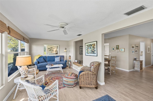 7122 11th Ave W, Bradenton, FL 34209 - living area featuring visible vents, wood finished floors, a textured ceiling, and ceiling fan