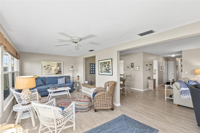 7122 11th Ave W, Bradenton, FL 34209 - living room with light wood finished floors, visible vents, baseboards, and a ceiling fan