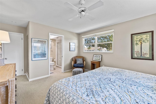 7122 11th Ave W, Bradenton, FL 34209 - bedroom featuring a textured ceiling, connected bathroom, baseboards, and light carpet