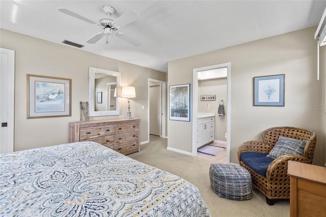 7122 11th Ave W, Bradenton, FL 34209 - bedroom with visible vents, light carpet, a ceiling fan, ensuite bath, and baseboards
