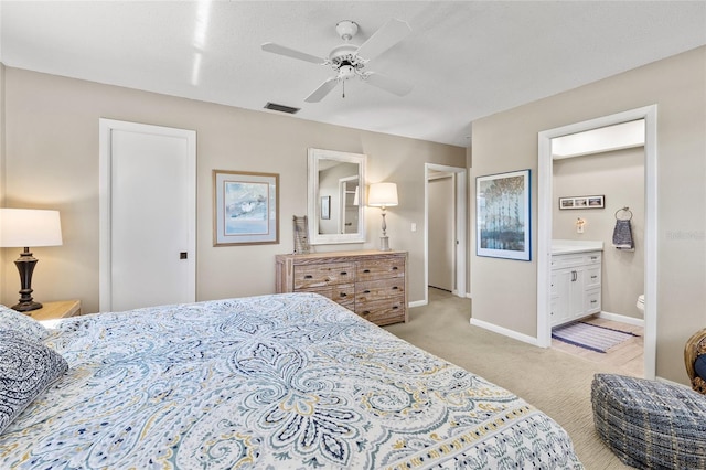 7122 11th Ave W, Bradenton, FL 34209 - bedroom with a ceiling fan, baseboards, visible vents, light carpet, and connected bathroom