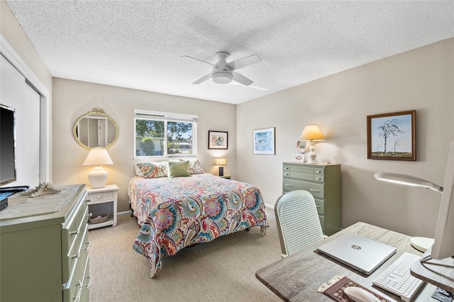 7122 11th Ave W, Bradenton, FL 34209 - bedroom featuring light carpet, a ceiling fan, a textured ceiling, a closet, and baseboards