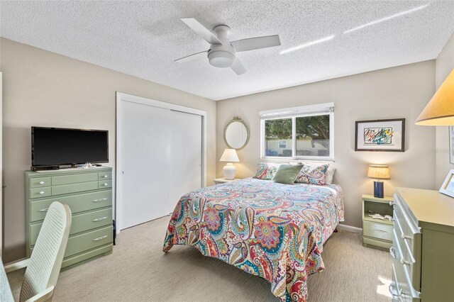 7122 11th Ave W, Bradenton, FL 34209 - bedroom with a closet, light colored carpet, ceiling fan, and a textured ceiling