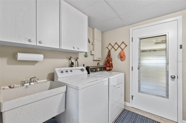 7122 11th Ave W, Bradenton, FL 34209 - laundry room featuring a sink, baseboards, cabinet space, and washer and clothes dryer