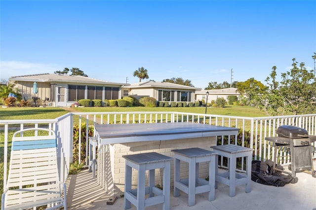 7122 11th Ave W, Bradenton, FL 34209 - view of patio with area for grilling, outdoor dry bar, and a sunroom