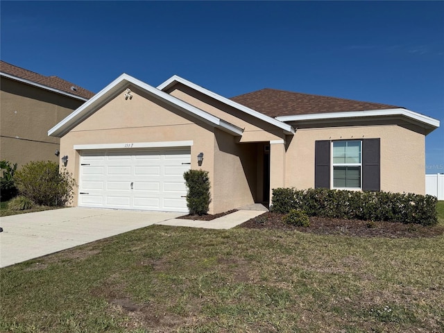 single story home with stucco siding, a garage, concrete driveway, and a front yard