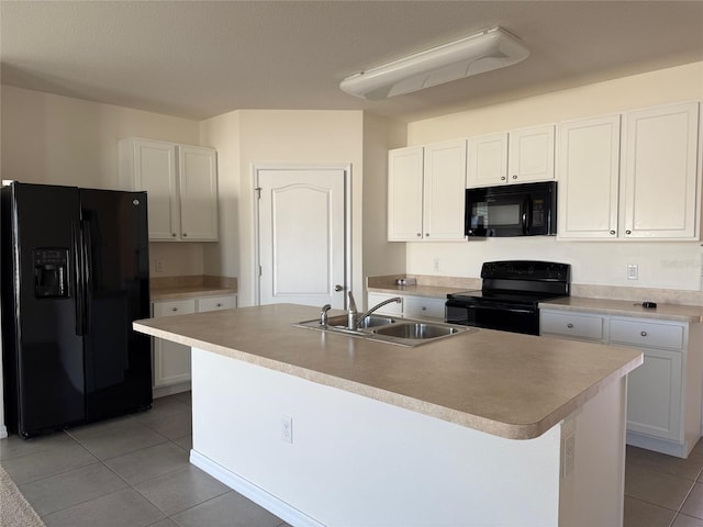kitchen featuring white cabinetry, black appliances, and a sink