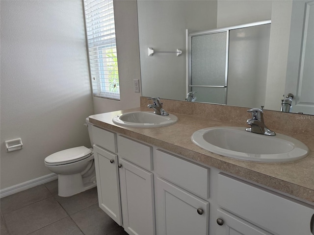 full bathroom with a sink, toilet, a stall shower, and tile patterned flooring