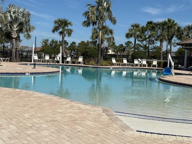 pool featuring a patio area and fence