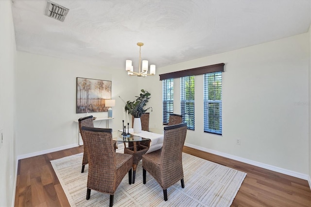 4406 17th St W, Palmetto, FL 34221 - dining space featuring a chandelier, wood finished floors, and baseboards