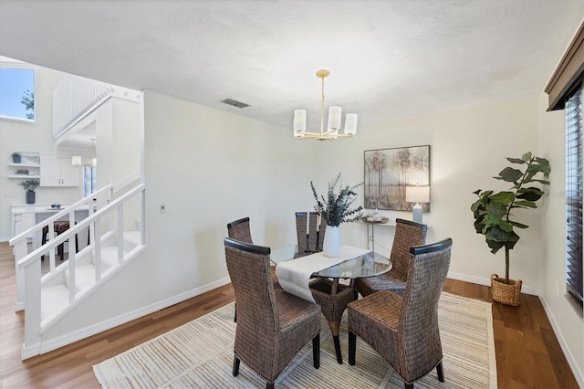 4406 17th St W, Palmetto, FL 34221 - dining area with a chandelier, wood finished floors, and baseboards