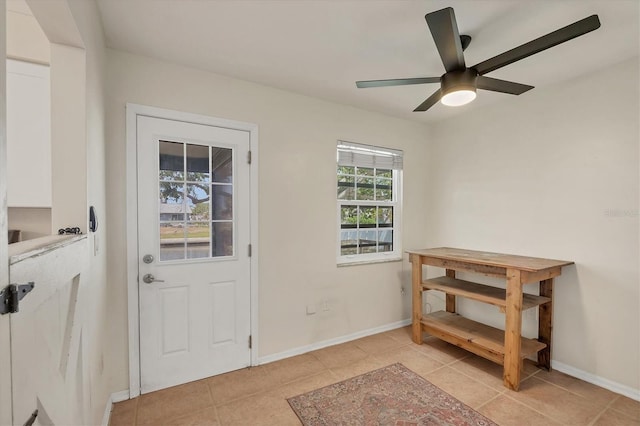 4406 17th St W, Palmetto, FL 34221 - doorway to outside featuring light tile patterned flooring, ceiling fan, and baseboards