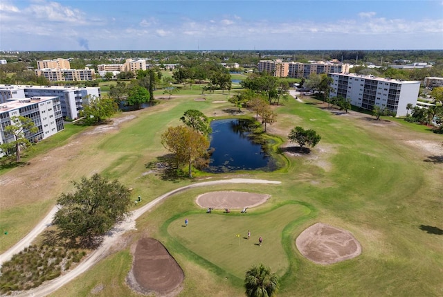 aerial view of apartment complex, a large body of water, and a local golf course