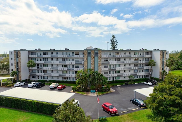 view of apartment building / complex with uncovered parking