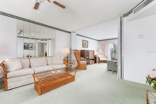 carpeted living room featuring ceiling fan