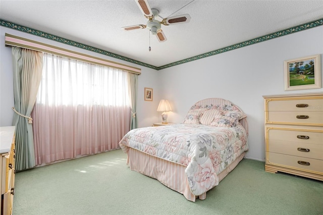 bedroom with carpet floors, a textured ceiling, and ceiling fan