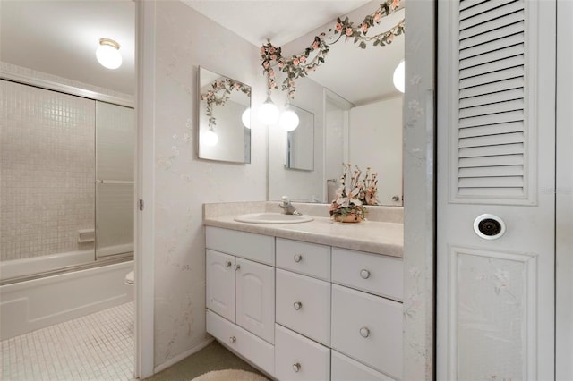 full bathroom featuring vanity, enclosed tub / shower combo, tile patterned floors, and toilet