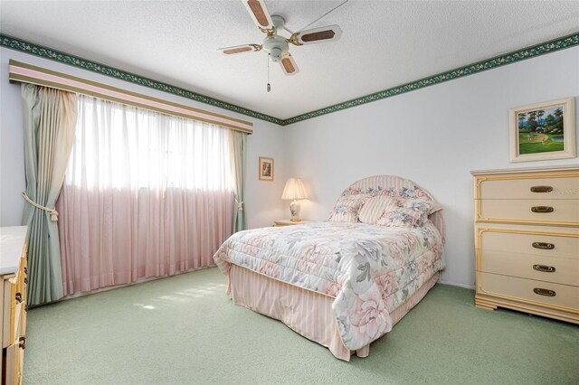 4440 Ironwood Cir Unit 509D, Bradenton, FL 34209 - bedroom with carpet flooring, a textured ceiling, and ceiling fan