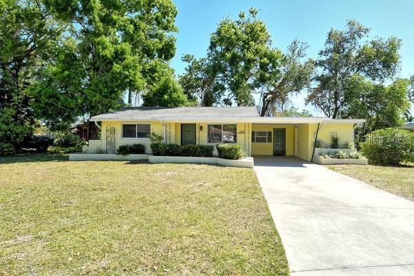 4560 Brooksdale Dr, Sarasota, FL 34232 - single story home with a front yard, concrete driveway, and a carport