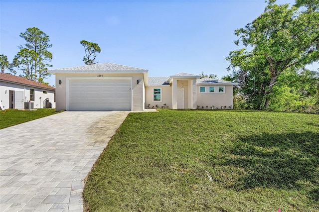 2364 Carpenter Ln, North Port, FL 34286 - view of front of property with stucco siding, decorative driveway, a front lawn, and an attached garage