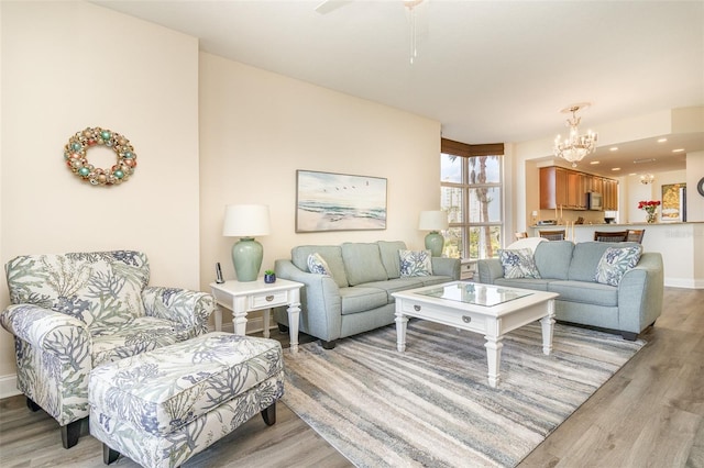 615 Riviera Dunes Way Unit 208, Palmetto, FL 34221 - living room featuring light wood-style floors and a chandelier