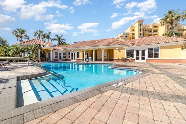 615 Riviera Dunes Way Unit 208, Palmetto, FL 34221 - community pool with french doors and a patio area