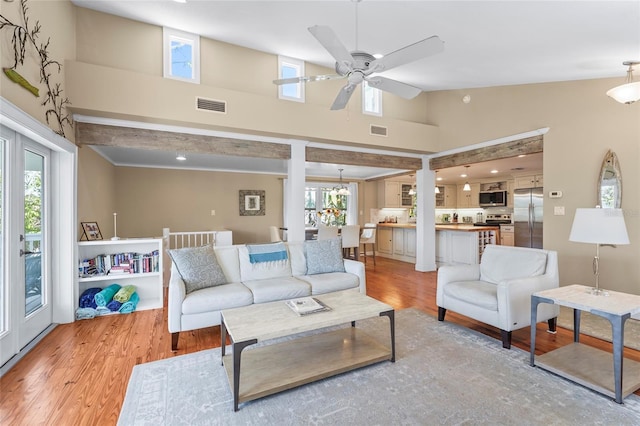 111 Faubel St, Sarasota, FL 34242 - living room with light wood finished floors, visible vents, and a healthy amount of sunlight
