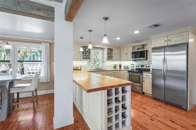 111 Faubel St, Sarasota, FL 34242 - kitchen with visible vents, decorative backsplash, a sink, and stainless steel appliances
