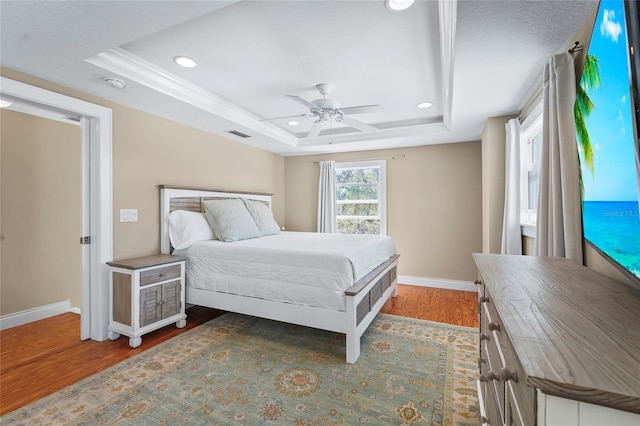 111 Faubel St, Sarasota, FL 34242 - bedroom with visible vents, baseboards, wood finished floors, recessed lighting, and a tray ceiling