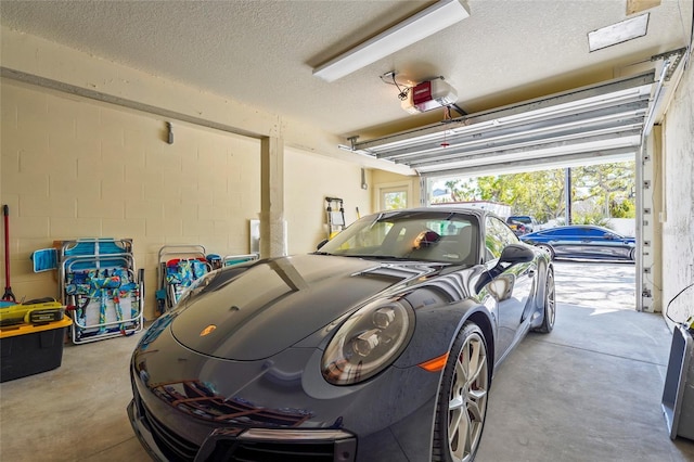 111 Faubel St, Sarasota, FL 34242 - garage with concrete block wall and a garage door opener