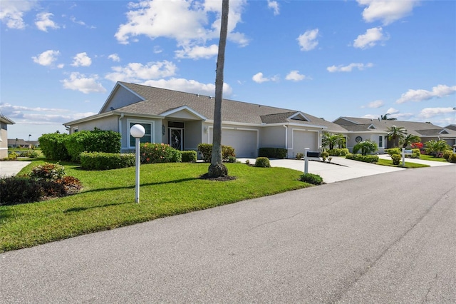 ranch-style home featuring stucco siding, concrete driveway, a garage, and a front yard