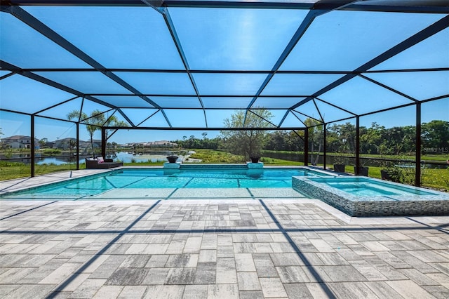 view of pool with a lanai, a pool with connected hot tub, and a patio