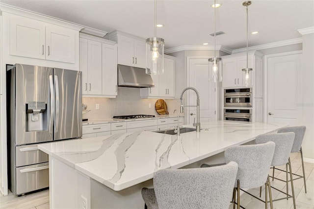 kitchen with decorative backsplash, stainless steel appliances, under cabinet range hood, and a sink