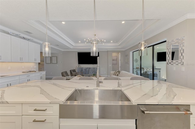 kitchen featuring open floor plan, recessed lighting, white cabinetry, crown molding, and a raised ceiling