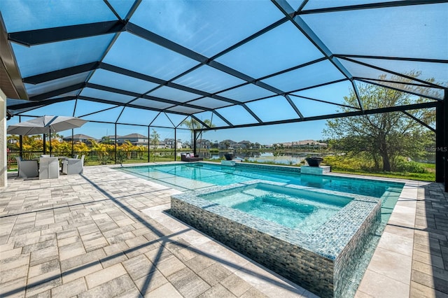 view of swimming pool featuring a pool with connected hot tub, a lanai, and a patio