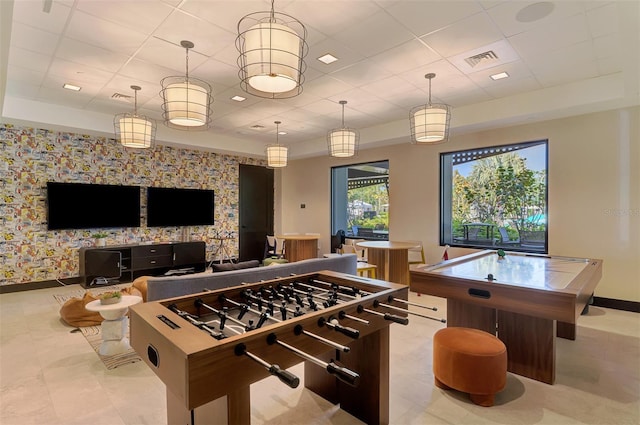 recreation room with baseboards, wallpapered walls, visible vents, and a paneled ceiling
