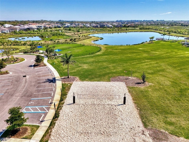 surrounding community with a lawn, a water view, and a residential view