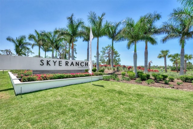 community / neighborhood sign featuring a lawn