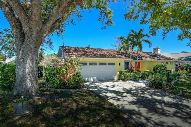 ranch-style home with driveway and a garage