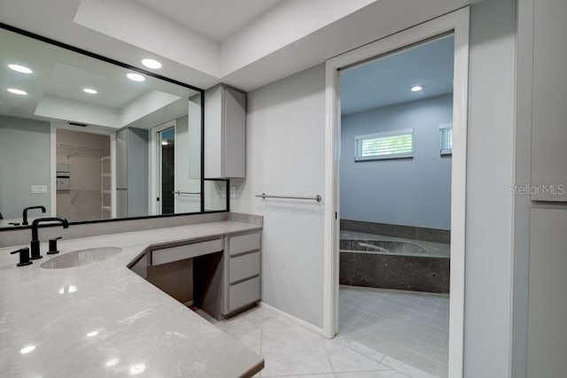 bathroom with vanity, recessed lighting, a spacious closet, tile patterned floors, and a garden tub