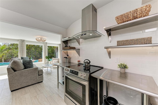 kitchen featuring open shelves, island exhaust hood, stainless steel range with electric cooktop, vaulted ceiling, and tasteful backsplash
