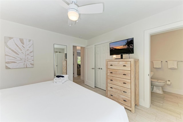 bedroom featuring a closet, baseboards, a ceiling fan, and ensuite bathroom